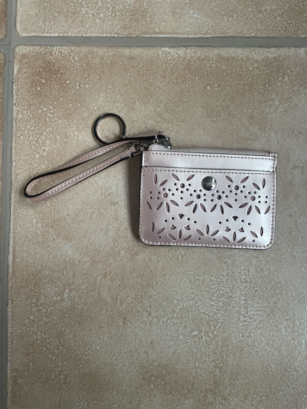 Coach floral  perforated leather wristlet with keychain, exterior front pocket